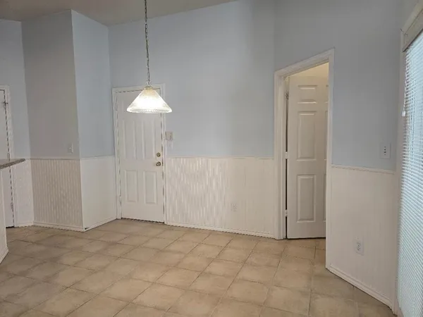 an empty room with a ceiling fan