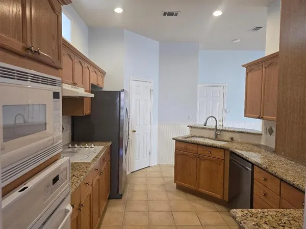 a kitchen with a sink stove and refrigerator