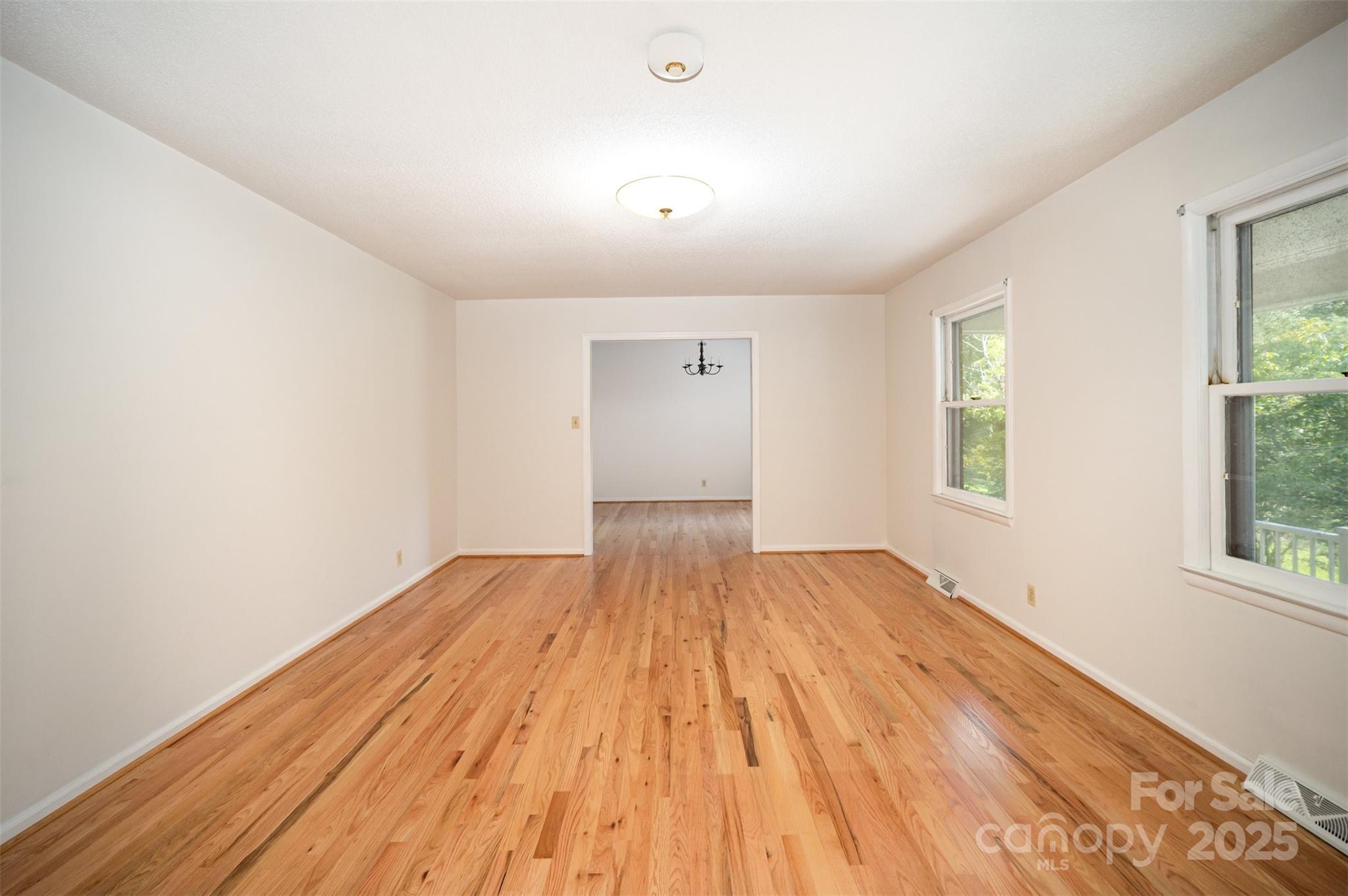 5474 Ussery Road Kershaw, SC 29067 - Photo 11 of 33 an empty room with wooden floor and windows