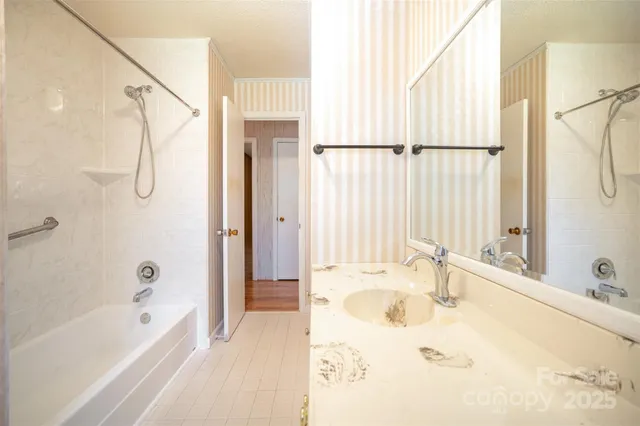 a bathroom with a tub a sink and a window