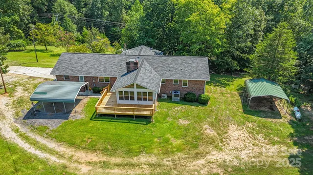 an aerial view of a house with swimming pool garden and patio