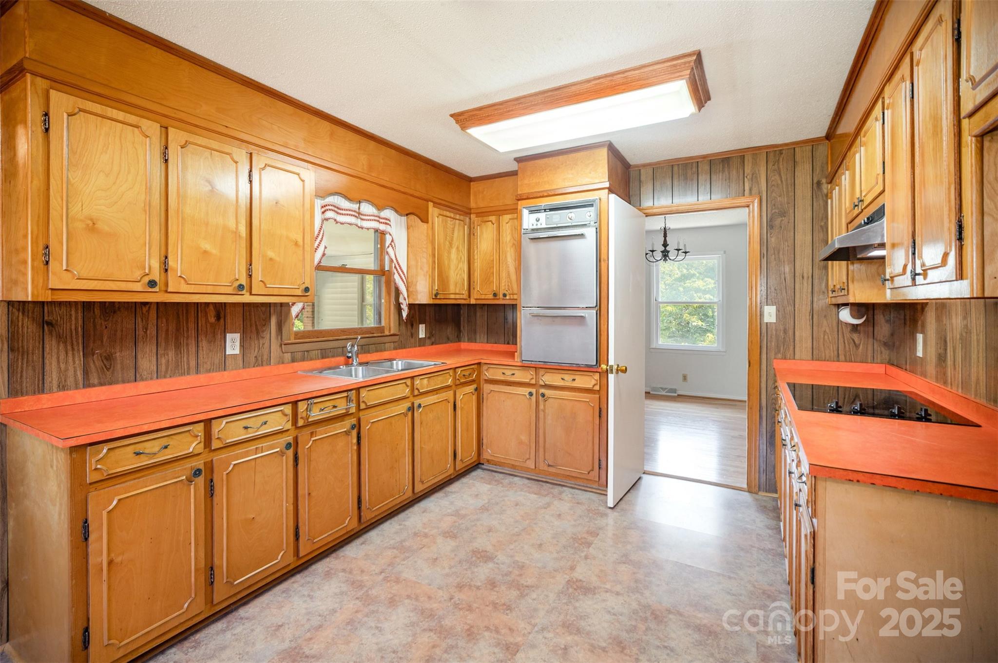 5474 Ussery Road Kershaw, SC 29067 - Photo 5 of 33 a large kitchen with stainless steel appliances granite countertop a refrigerator a stove and a sink with wooden cabinets