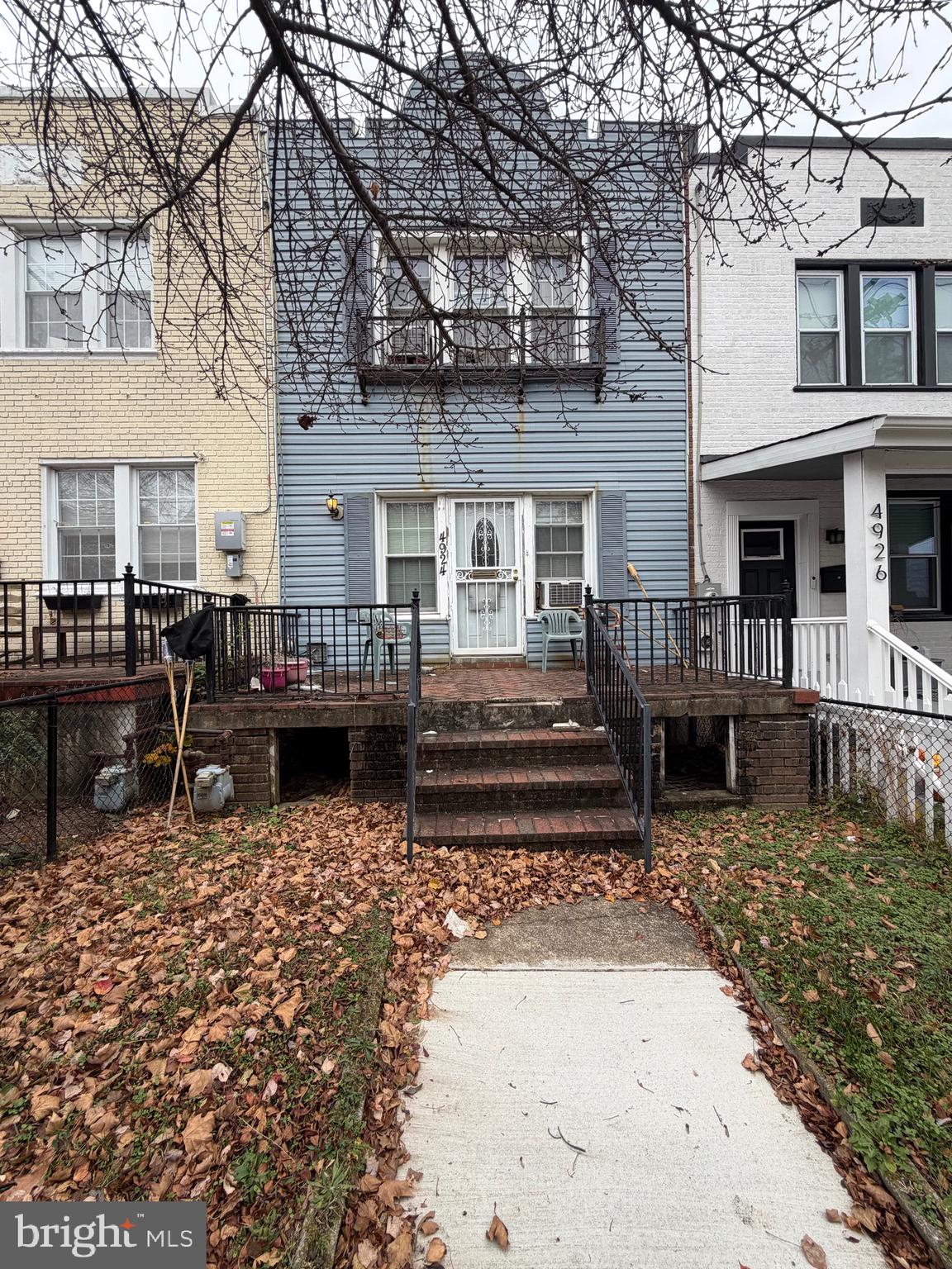 a view of a house with wooden floor in front of house