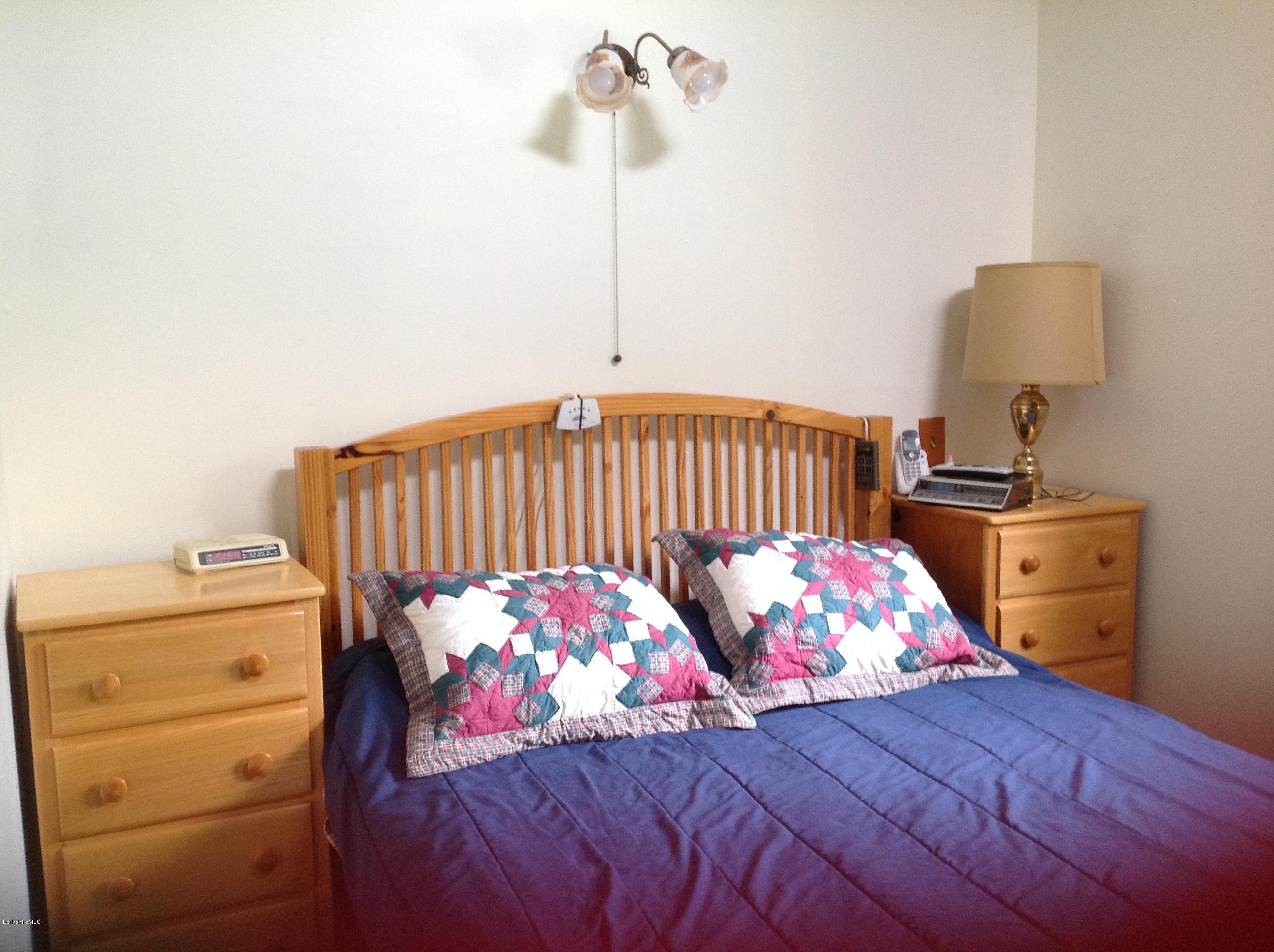 604 East Windsor Road Windsor, MA 01270 - Photo 16 of 28 a bedroom with a bed and a chandelier