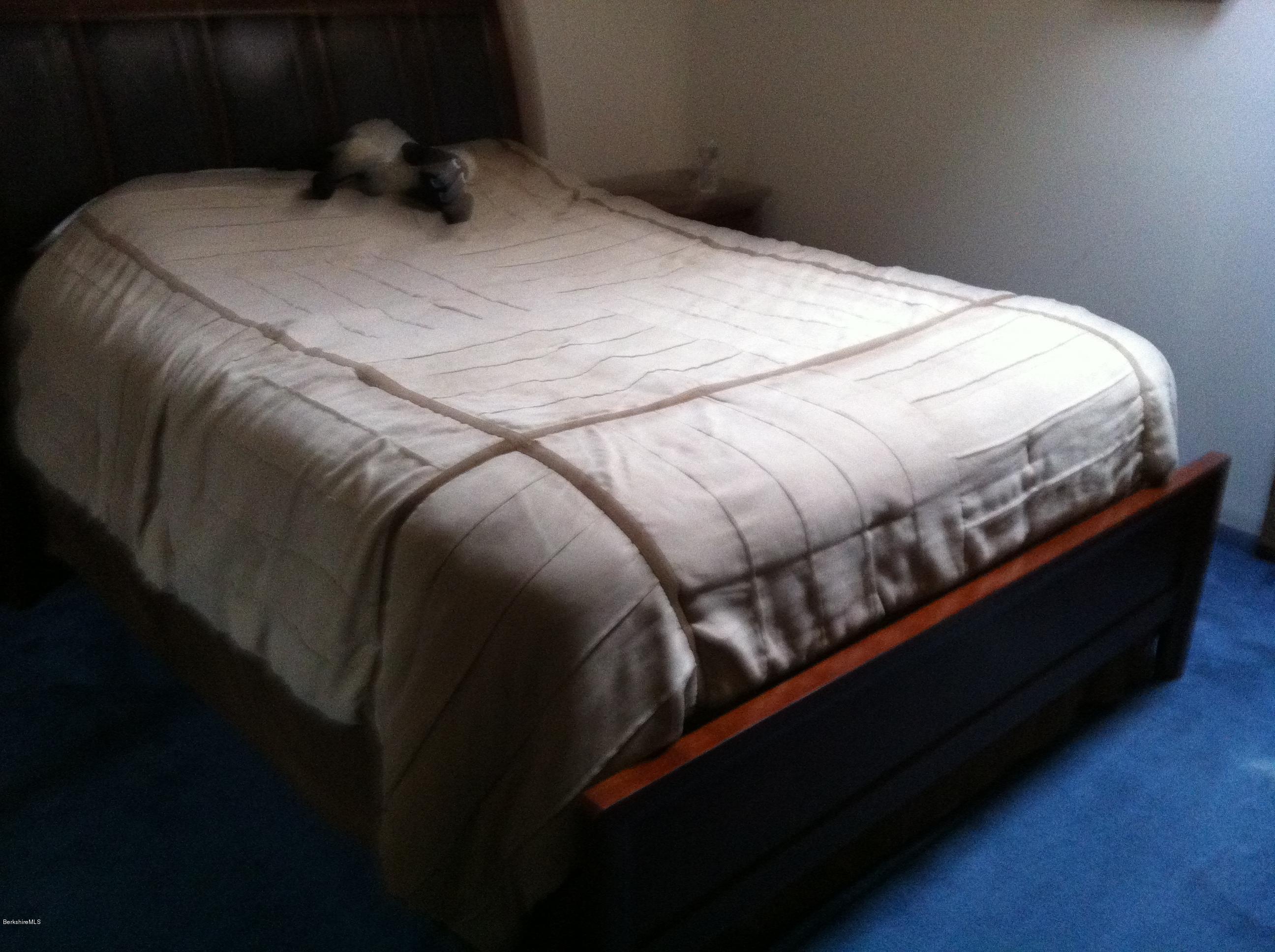 604 East Windsor Road Windsor, MA 01270 - Photo 25 of 28 a bed sitting in a bedroom next to a lamp