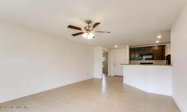 a view of a kitchen with a sink and a ceiling fan