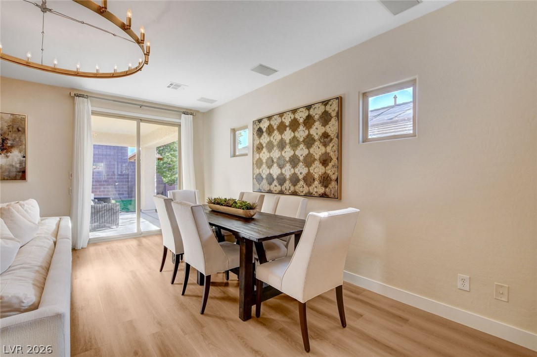 2649 Rue Marquette Avenue Henderson, NV 89044 - Photo 16 of 55 This versatile open-concept space features natural wood flooring and provides seamless access to the outdoors through sliding glass doors.