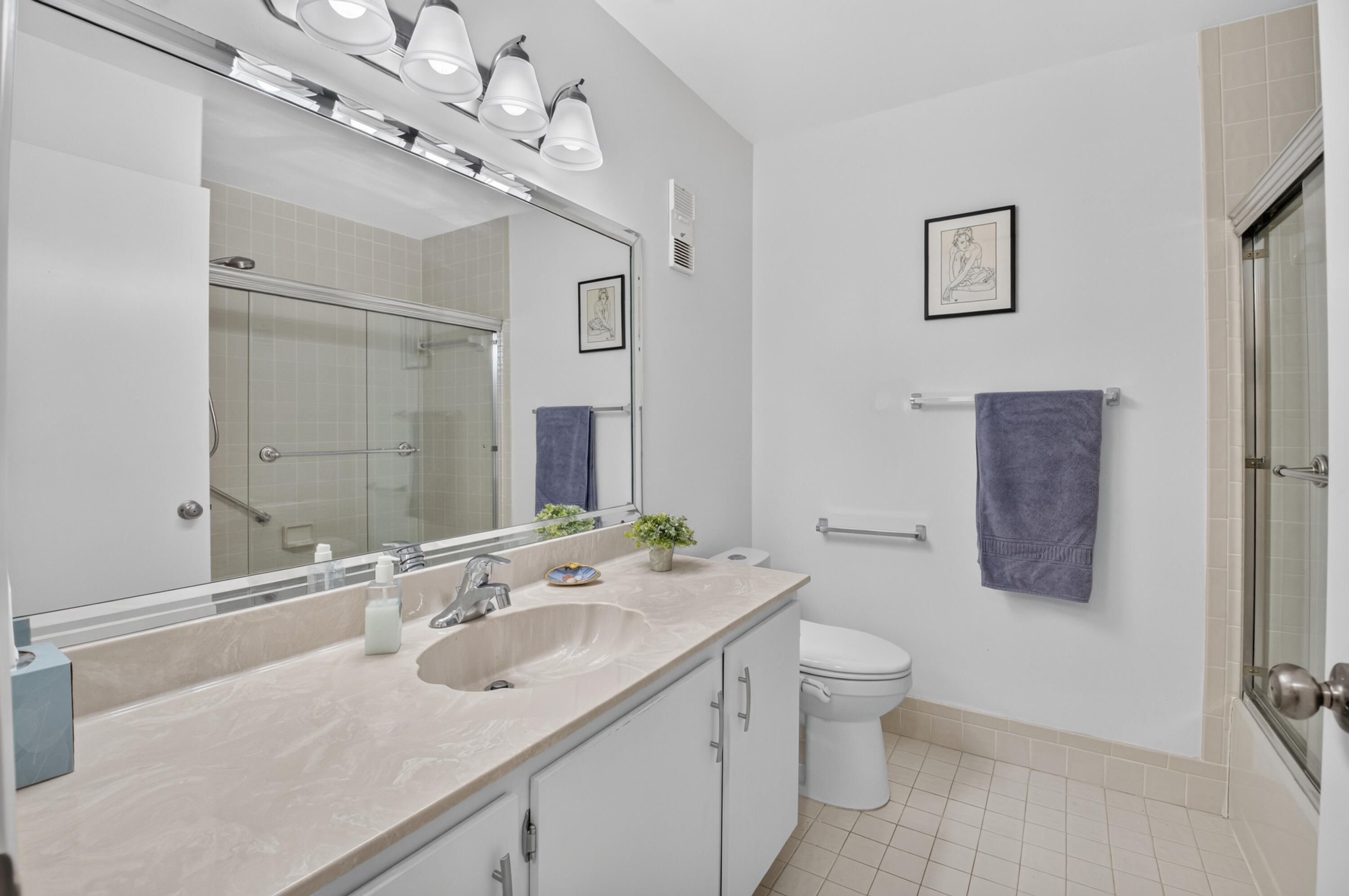 8246 Springview Terrace Boca Raton, FL 33496 - Photo 26 of 53 a bathroom with a sink a toilet a mirror and shower