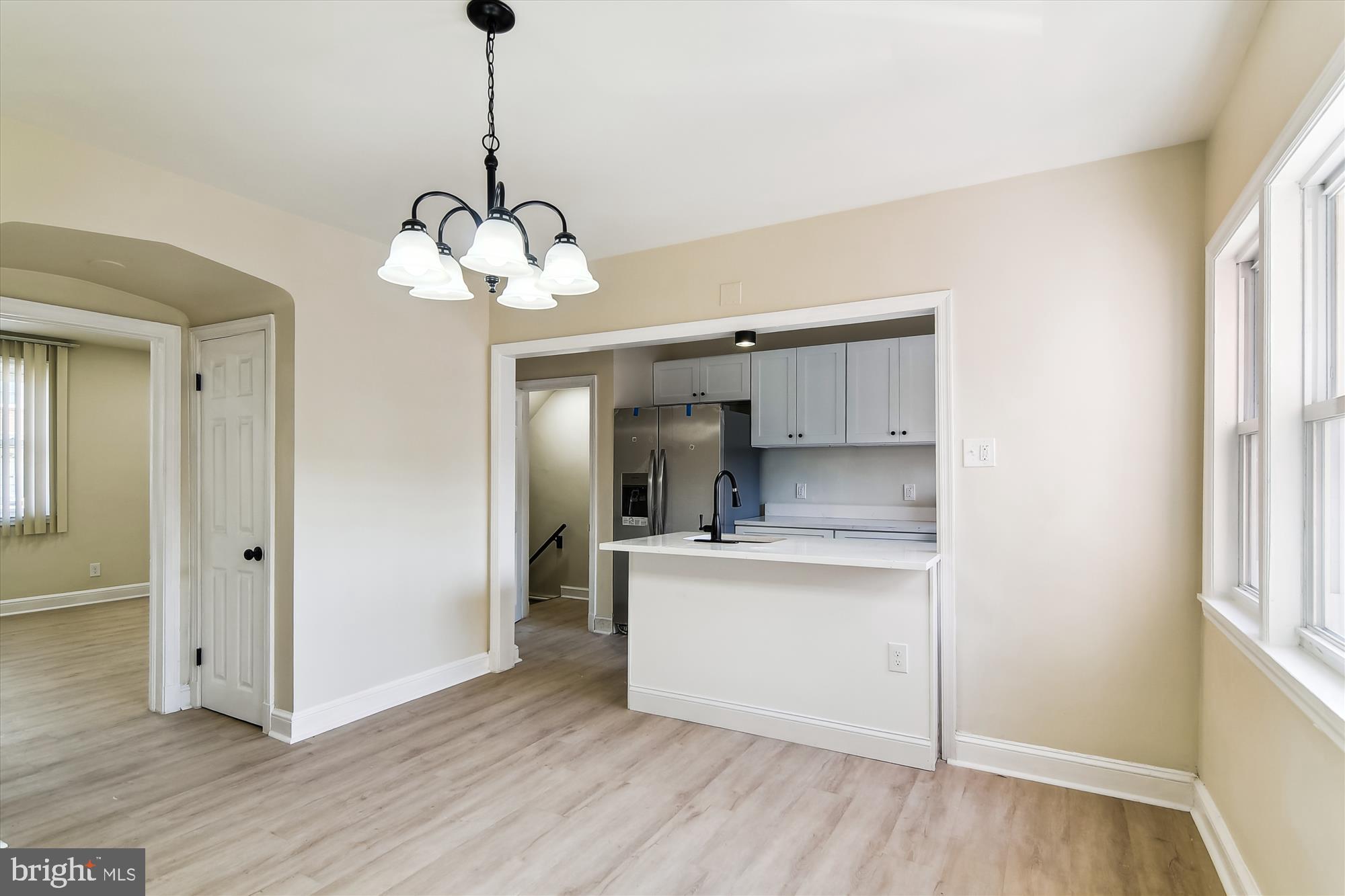 3312 Royce Avenue Baltimore, MD 21215 - Photo 11 of 20 a view of a kitchen with a sink wooden cabinets and a window