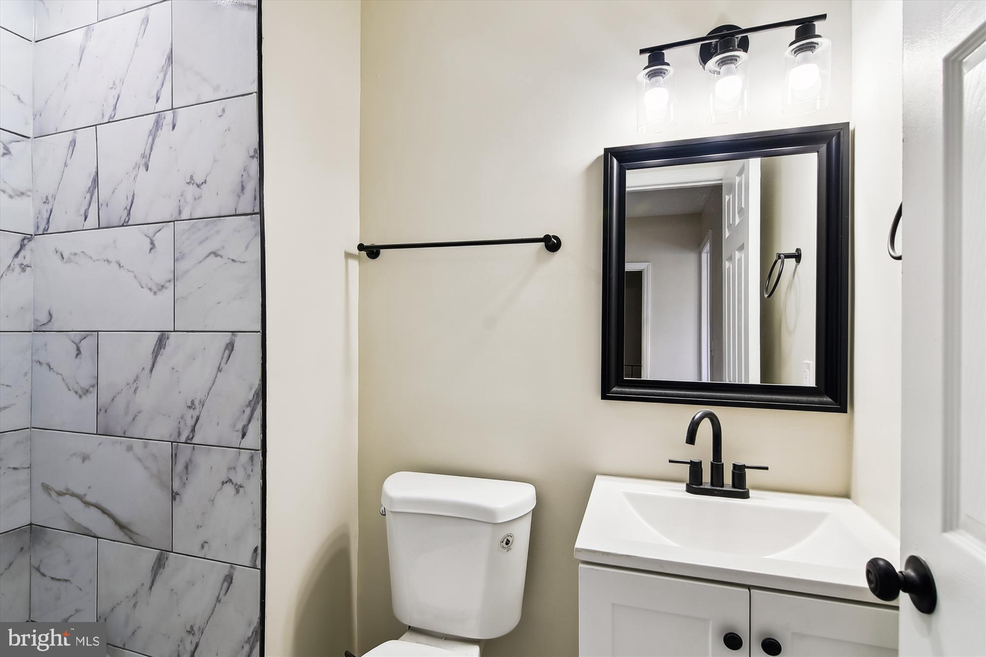 3312 Royce Avenue Baltimore, MD 21215 - Photo 13 of 20 a bathroom with a toilet sink and mirror