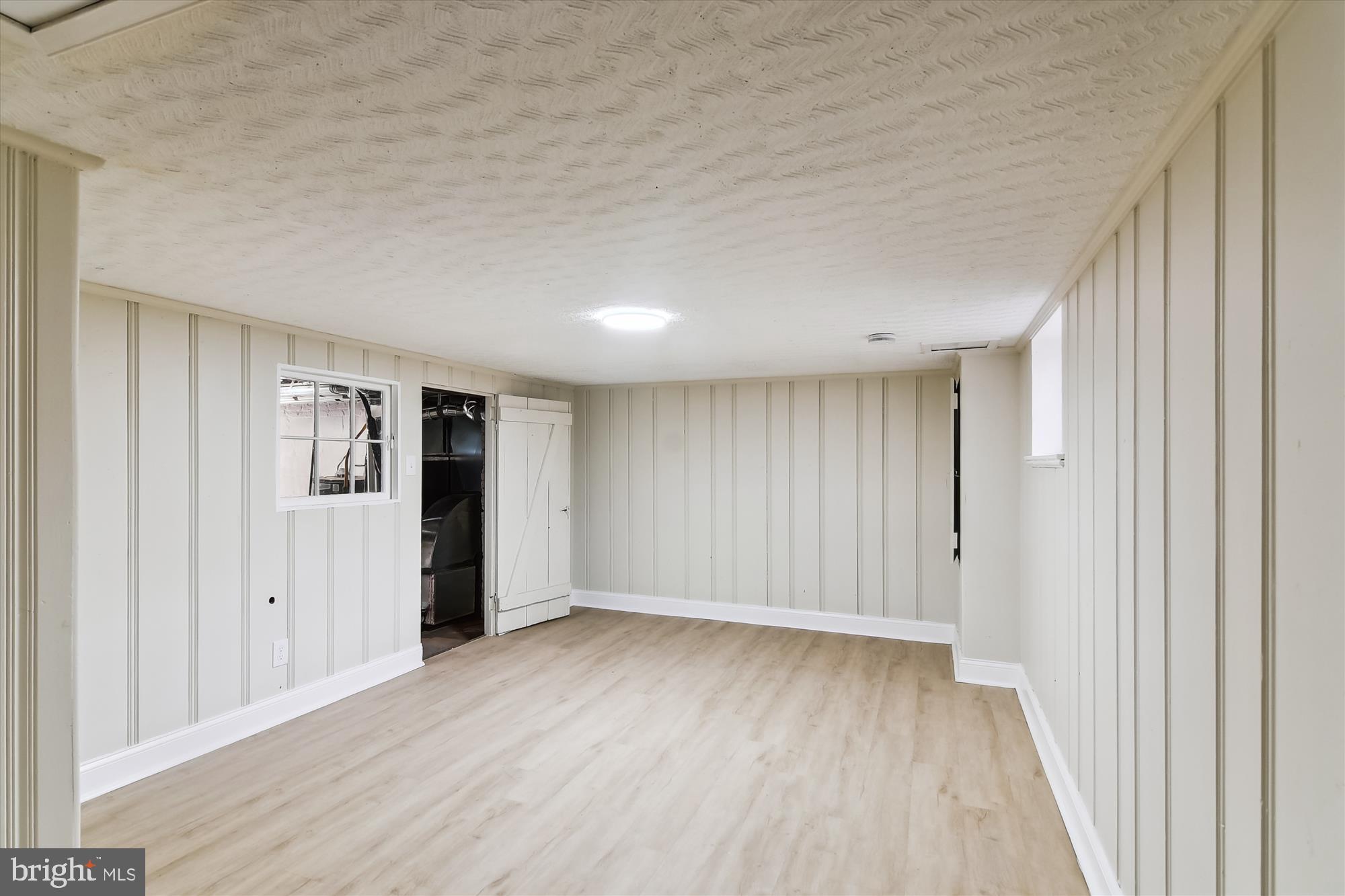 3312 Royce Avenue Baltimore, MD 21215 - Photo 17 of 20 a view of an empty room with wooden floor