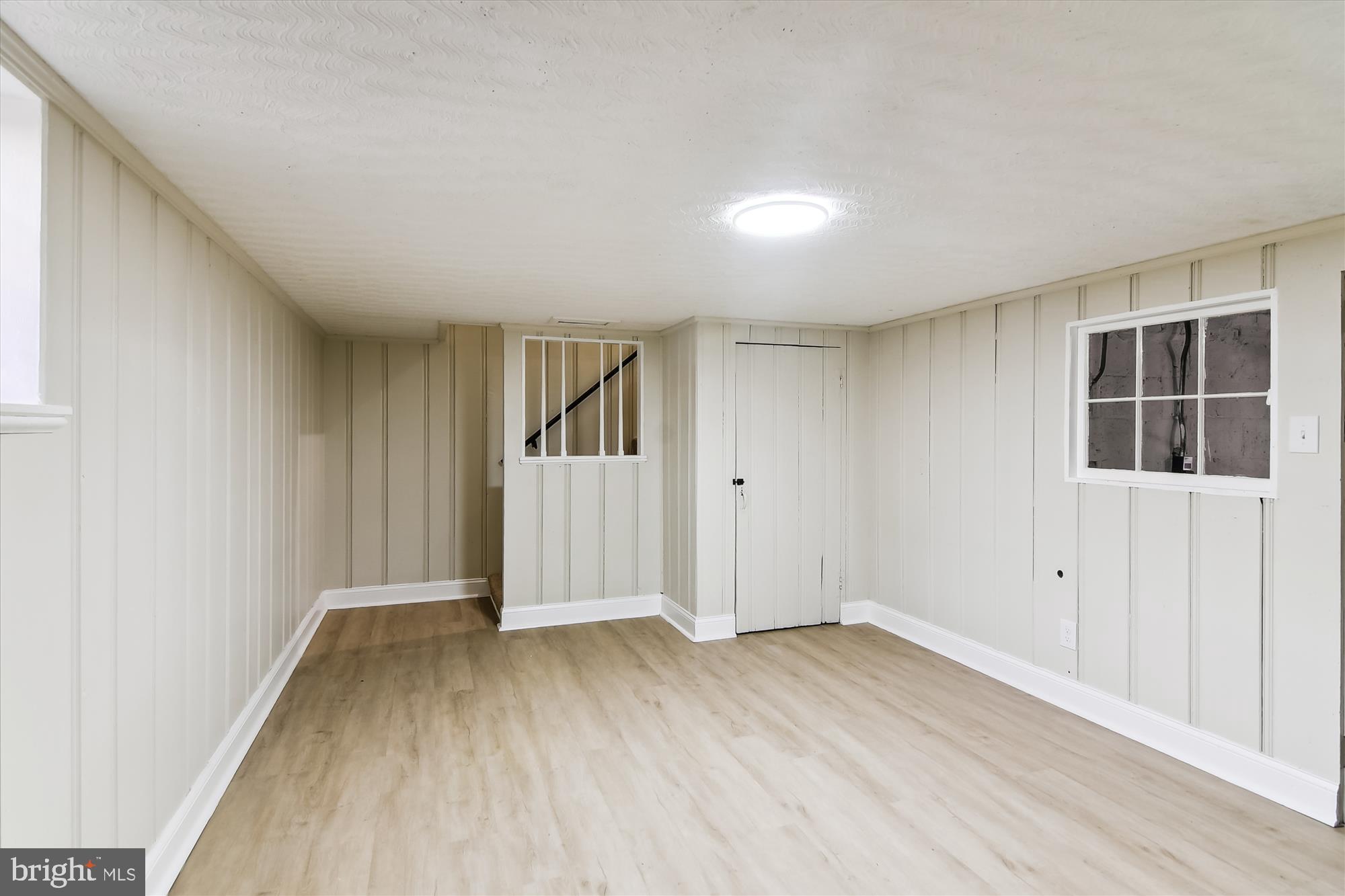 3312 Royce Avenue Baltimore, MD 21215 - Photo 18 of 20 an empty room with wooden floor and windows