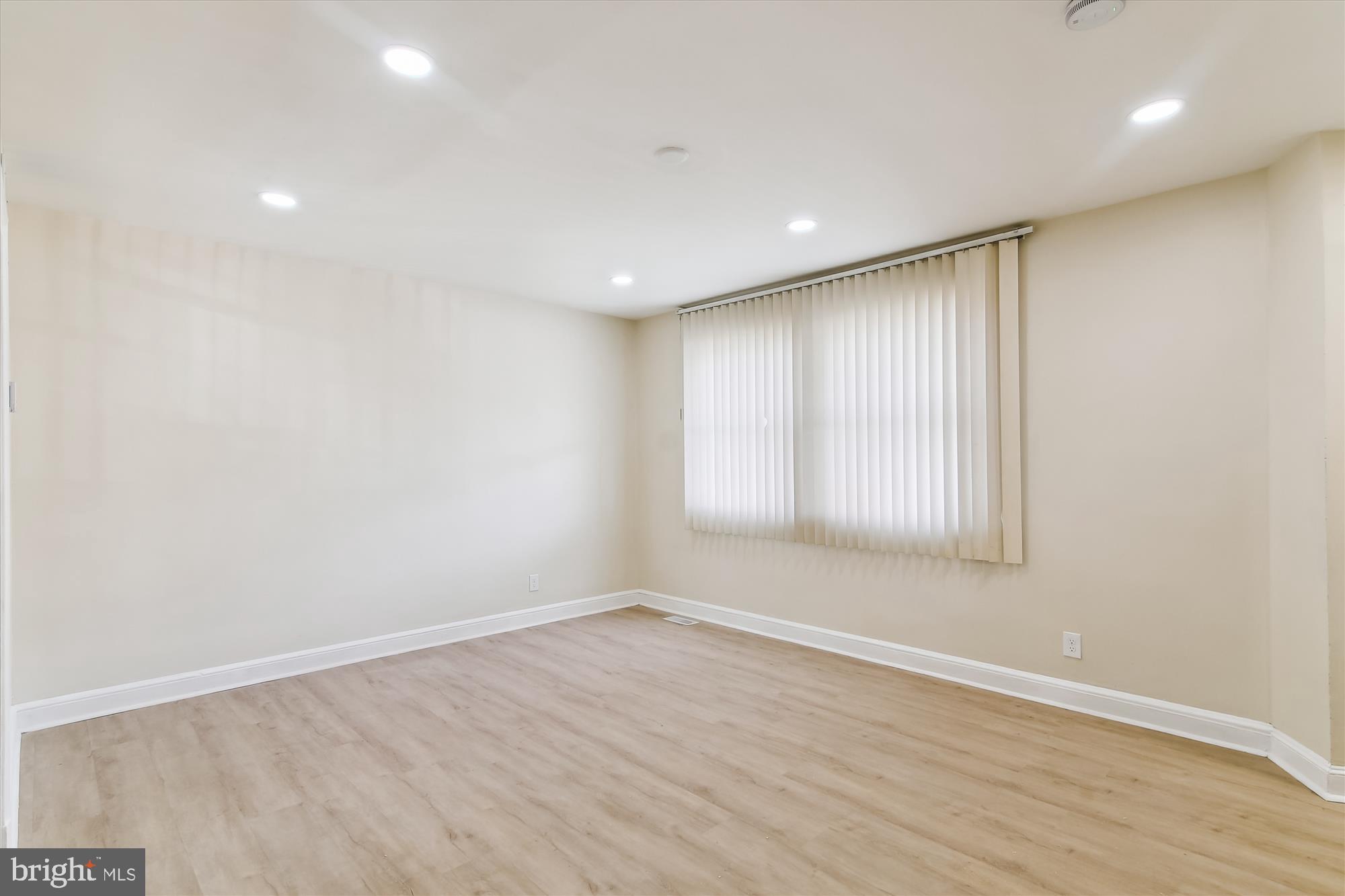 3312 Royce Avenue Baltimore, MD 21215 - Photo 4 of 20 wooden floor in an empty room with a window