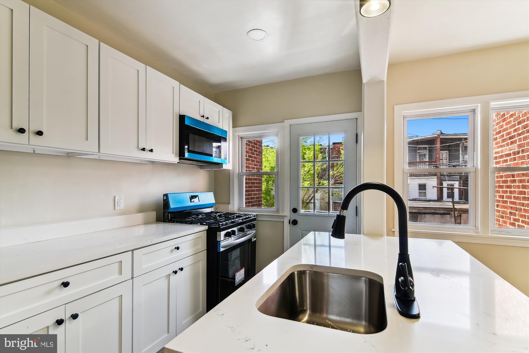 3312 Royce Avenue Baltimore, MD 21215 - Photo 6 of 20 a kitchen with stainless steel appliances a sink a stove and cabinets