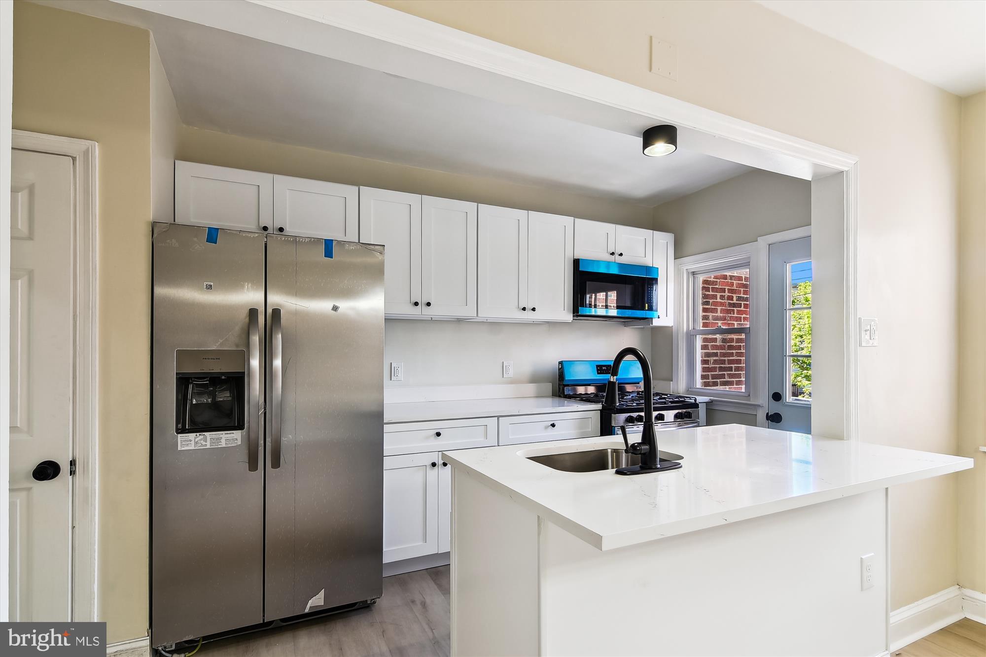 3312 Royce Avenue Baltimore, MD 21215 - Photo 7 of 20 a kitchen with a sink a refrigerator and a sink