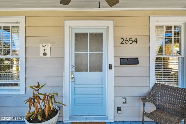 a living room with furniture and a mirror