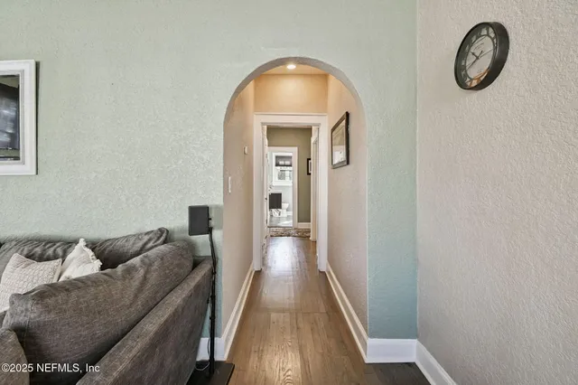 a living room with furniture a rug and a window