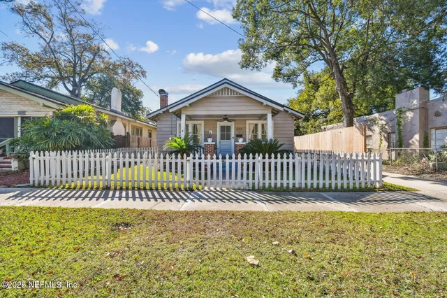 a view of a porch with furniture and wooden floor
