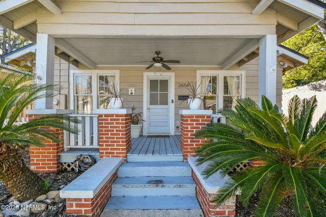 a living room with fireplace furniture and a flat screen tv