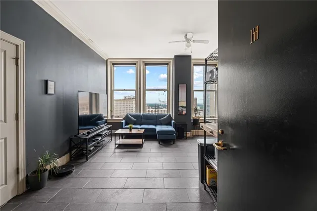 a living room with furniture gym equipment and a large window