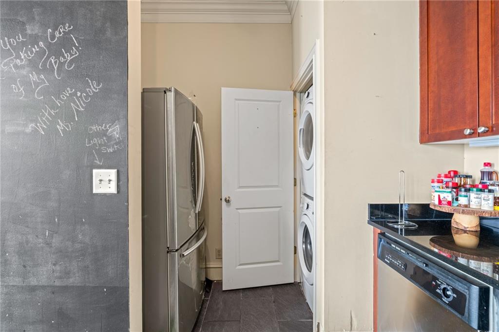 57 Forsyth Street Northwest, Unit 14H Atlanta, GA 30303 - Photo 11 of 42 a kitchen with a refrigerator and cabinets