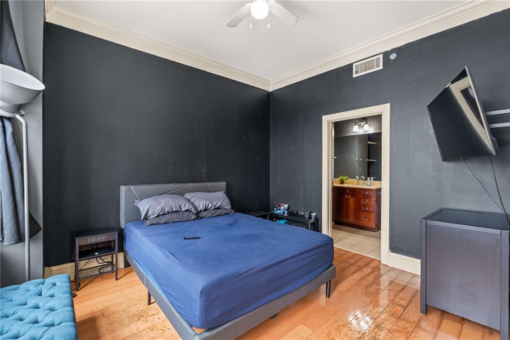 57 Forsyth Street Northwest, Unit 14H Atlanta, GA 30303 - Photo 12 of 42 a bedroom with a bed and a television in it
