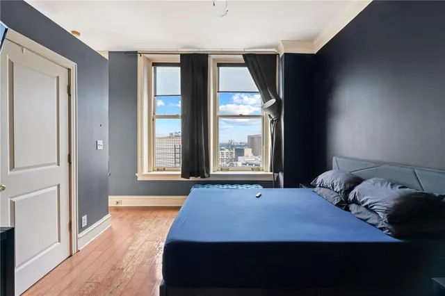 a bedroom with a bed and wooden floor