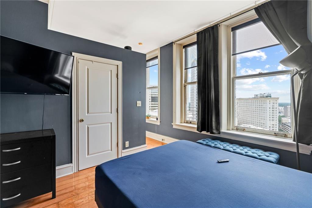 57 Forsyth Street Northwest, Unit 14H Atlanta, GA 30303 - Photo 17 of 42 a view of an empty room with a window and wooden floor
