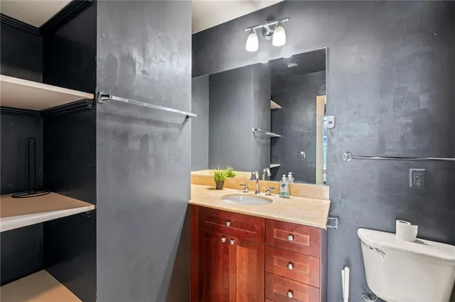 a bathroom with a sink vanity toilet and shower