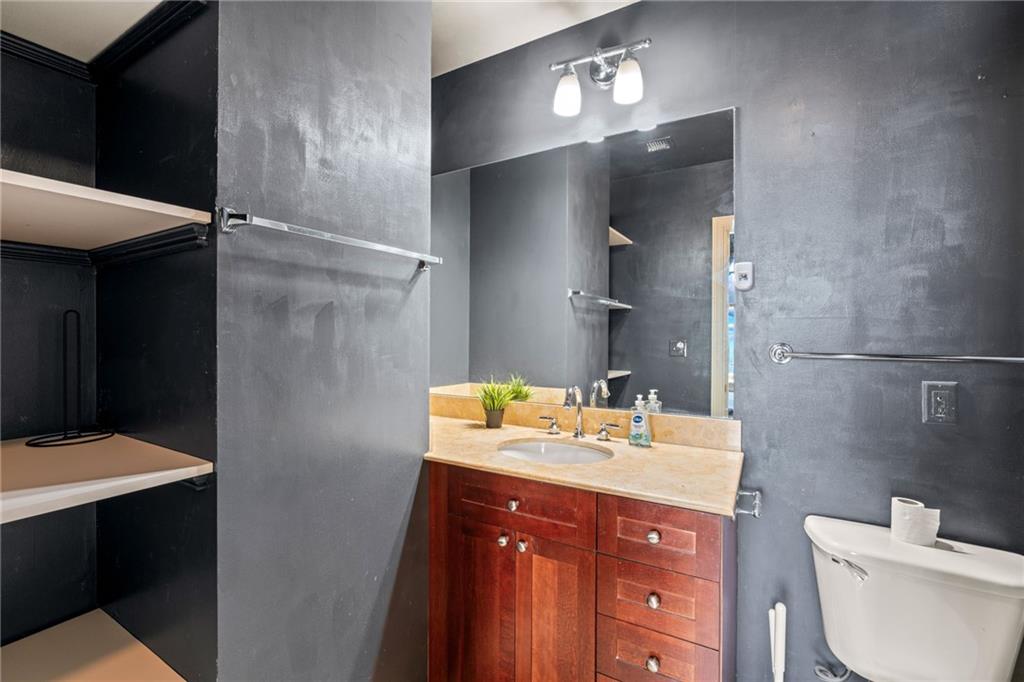 57 Forsyth Street Northwest, Unit 14H Atlanta, GA 30303 - Photo 19 of 42 a bathroom with a sink vanity toilet and shower