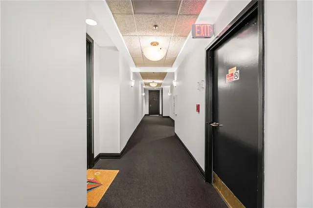 a view of a hallway with wooden floor and a hallway