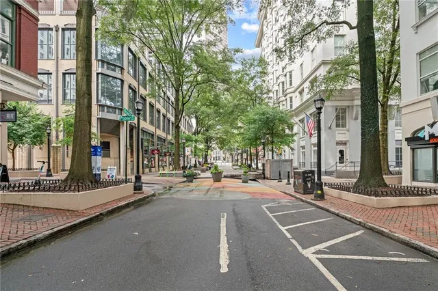 a view of a street that has couple of cars parked on the road