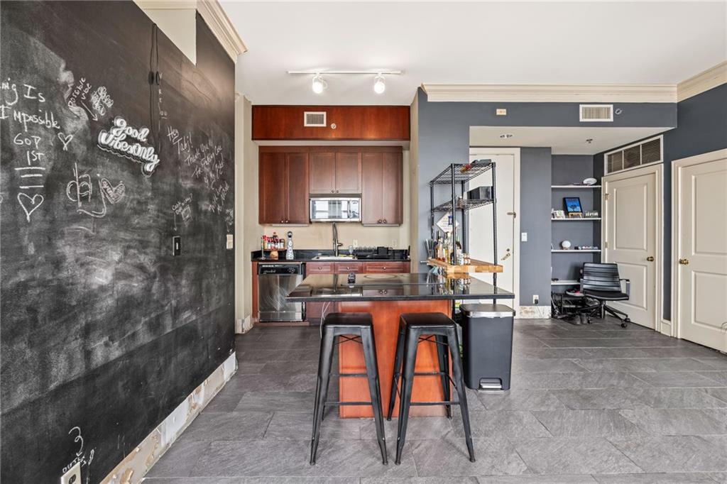 57 Forsyth Street Northwest, Unit 14H Atlanta, GA 30303 - Photo 8 of 42 a room with stainless steel appliances kitchen island granite countertop furniture and a living room