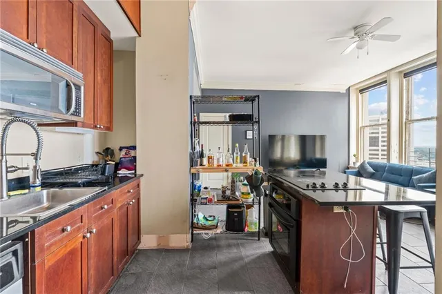 a kitchen with stainless steel appliances a stove sink microwave and cabinets