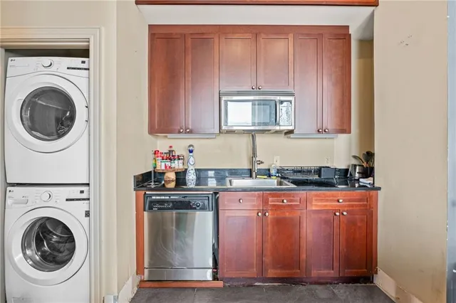 a kitchen with granite countertop a sink and a stove top oven