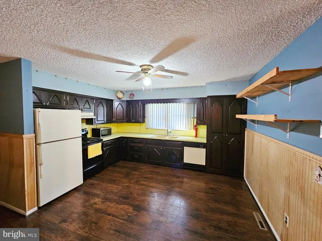 a kitchen with a refrigerator and a sink