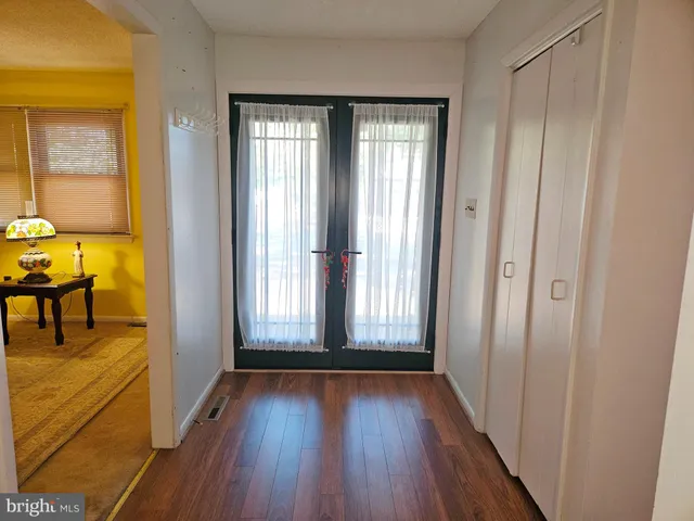 a view of a livingroom with a ceiling fan window and hardwood floor