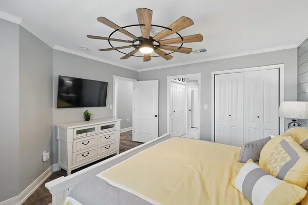 a bedroom with a bed and a flat screen tv