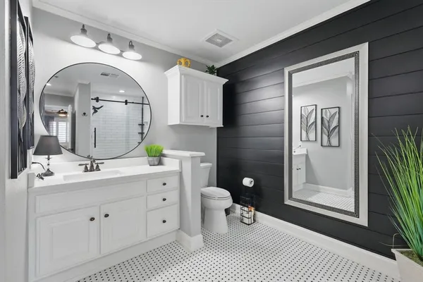 a bathroom with a double vanity sink and a mirror