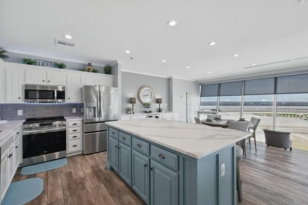 a kitchen with stainless steel appliances a stove sink and microwave