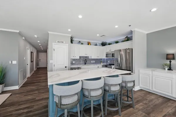 a kitchen with stainless steel appliances granite countertop a sink and cabinets