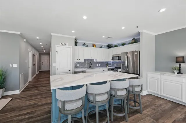 a kitchen with stainless steel appliances granite countertop a sink and cabinets