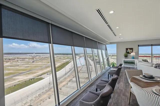 a view of a living room and floor to ceiling window or wooden floor