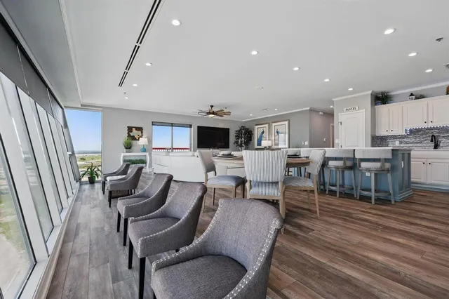 a living room with lots of furniture and kitchen view