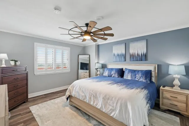 a bedroom with a large bed and a window