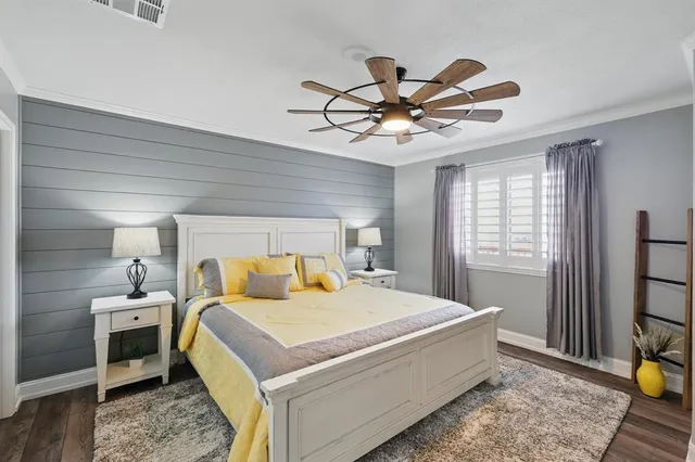 a bedroom with a bed and ceiling fan