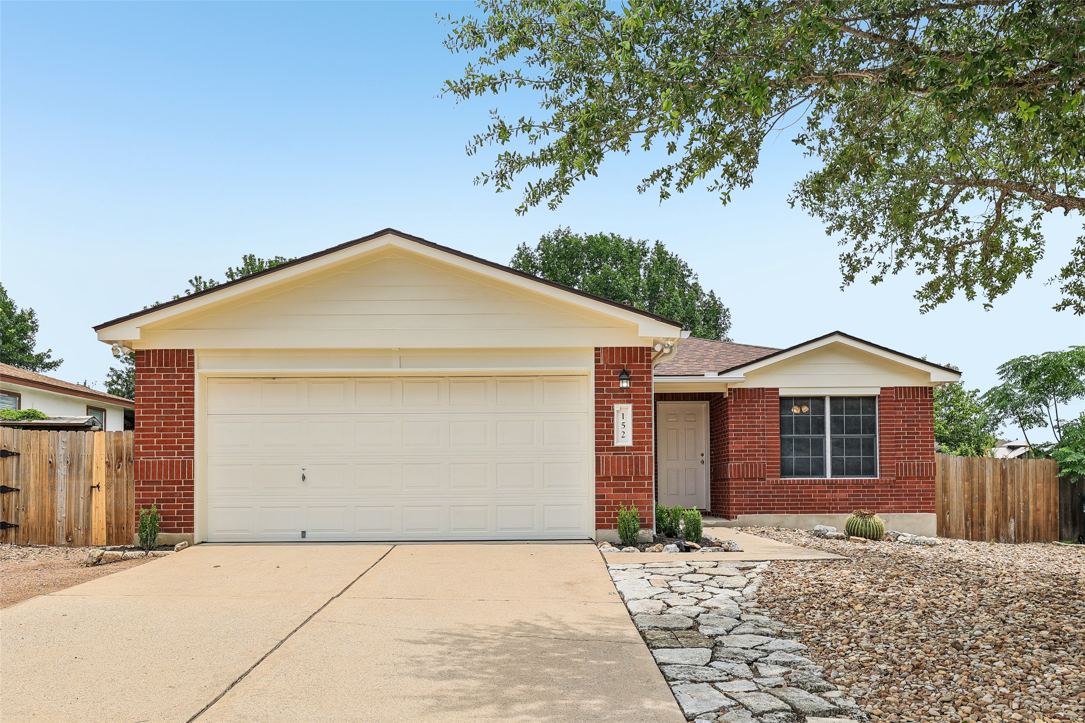 152 Grant Way Kyle, TX 78640 - Photo 1 of 39 a front view of a house with a yard