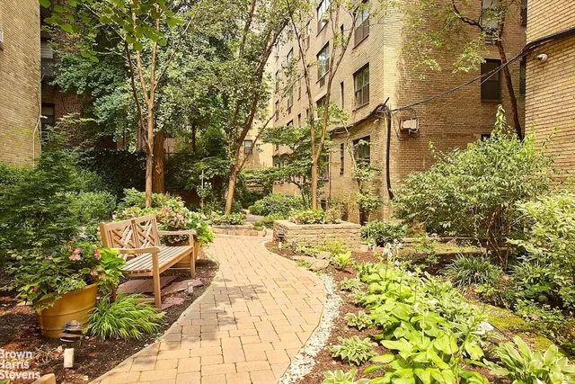 a living room with furniture and a lamp