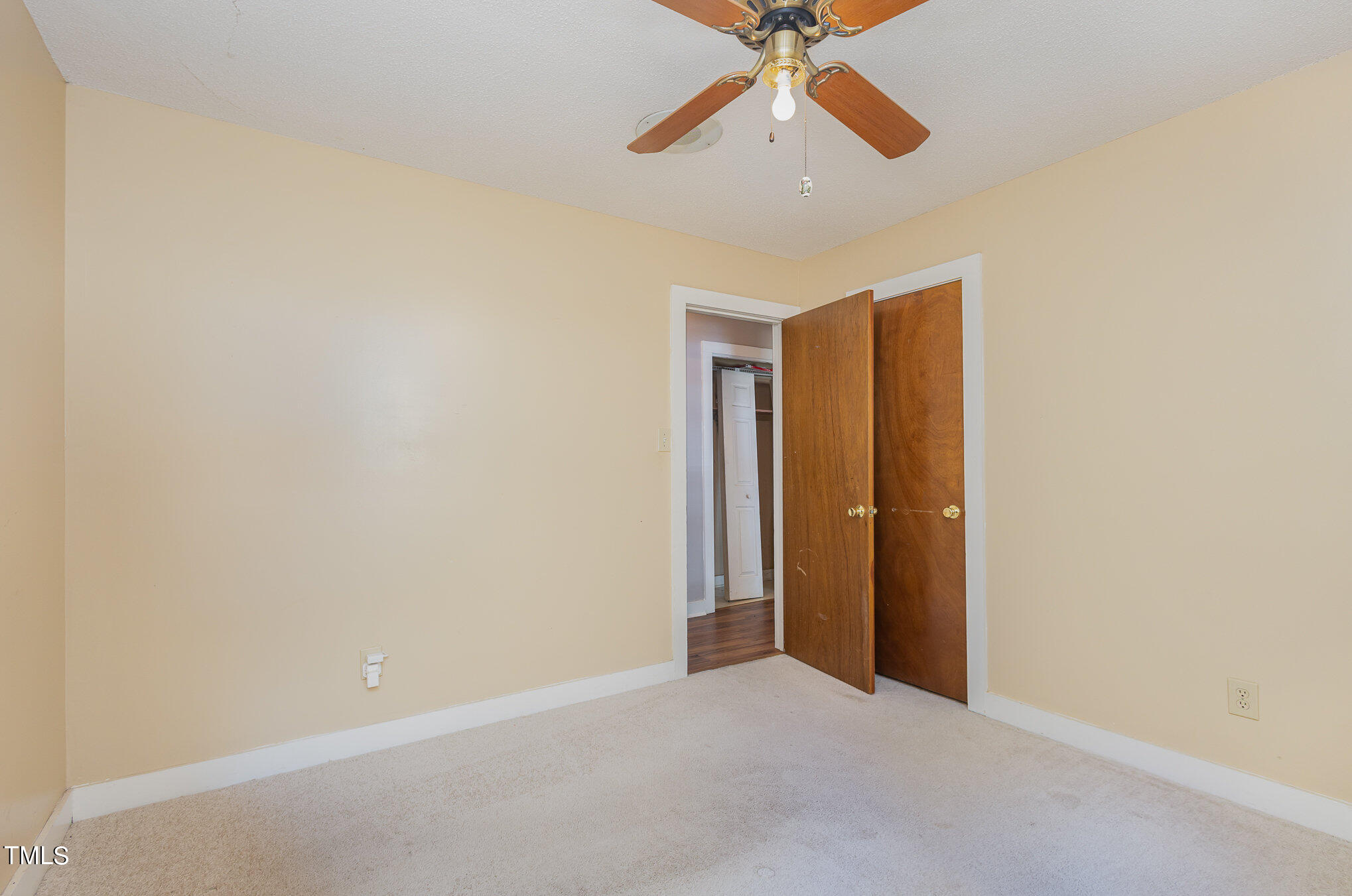 814 Wyldewood Road Durham, NC 27704 - Photo 17 of 26 an empty room with closet and a chandelier fan