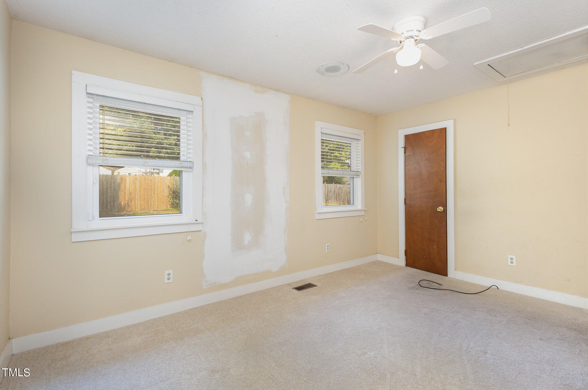 814 Wyldewood Road Durham, NC 27704 - Photo 20 of 26 an empty room with windows and fan